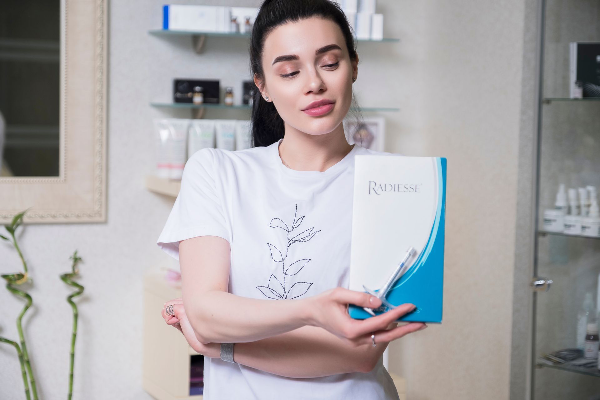 A woman is holding a box in her hands in a salon.