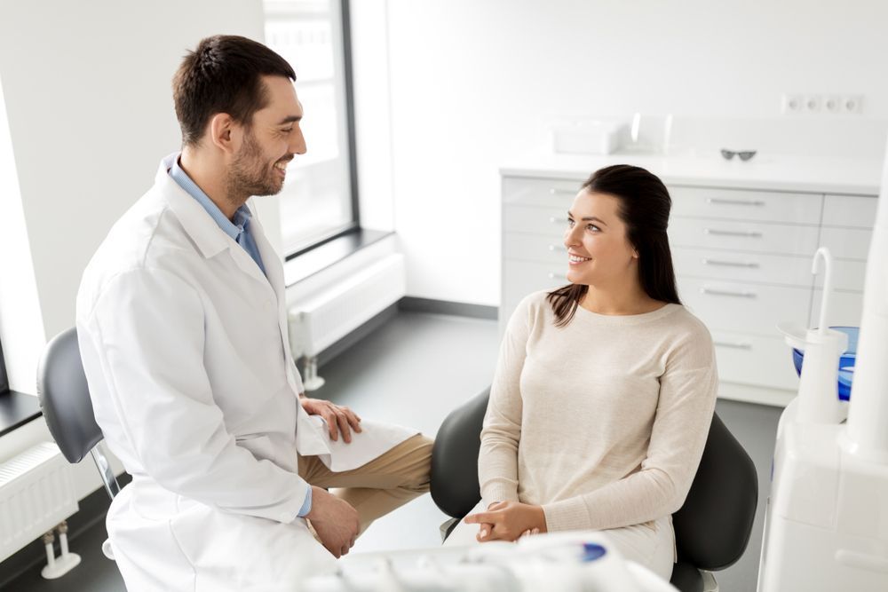 Male Dentist Talking to Female Patient — Dental Clinic in Mooloolaba, QLD
