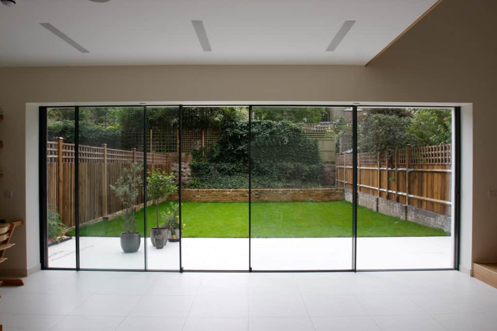 A room with sliding glass doors leading to a backyard