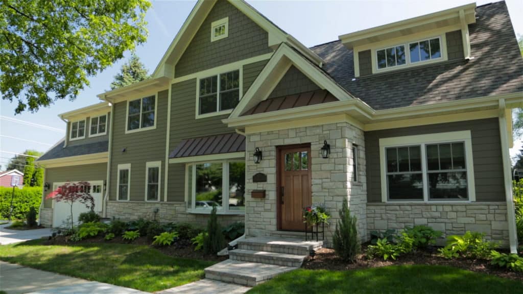 A large house with a lot of windows and a wooden door