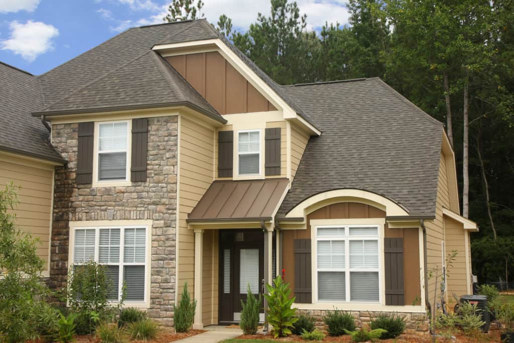 A large house with a gray roof and lots of windows