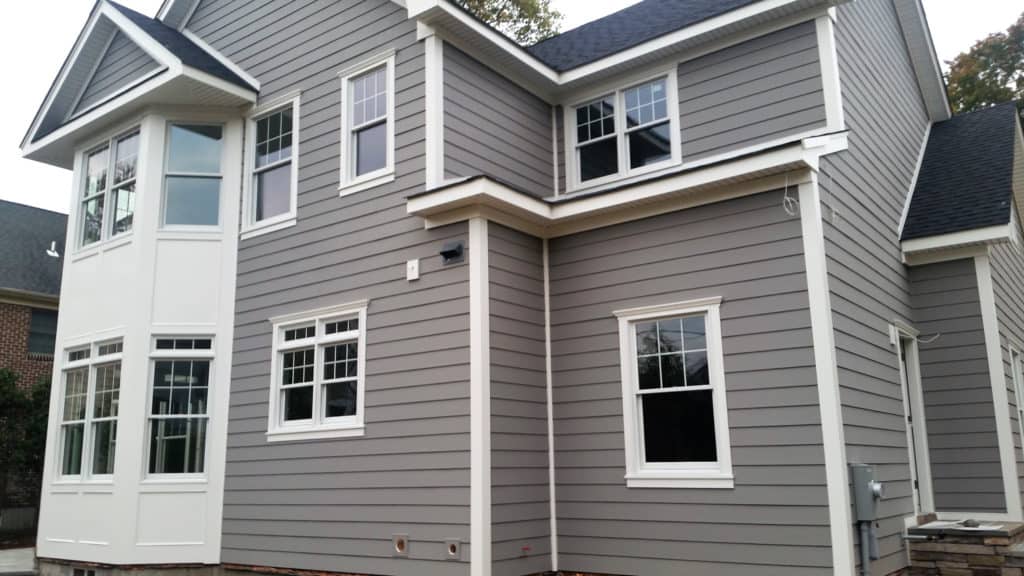 A large gray and white house with a lot of windows