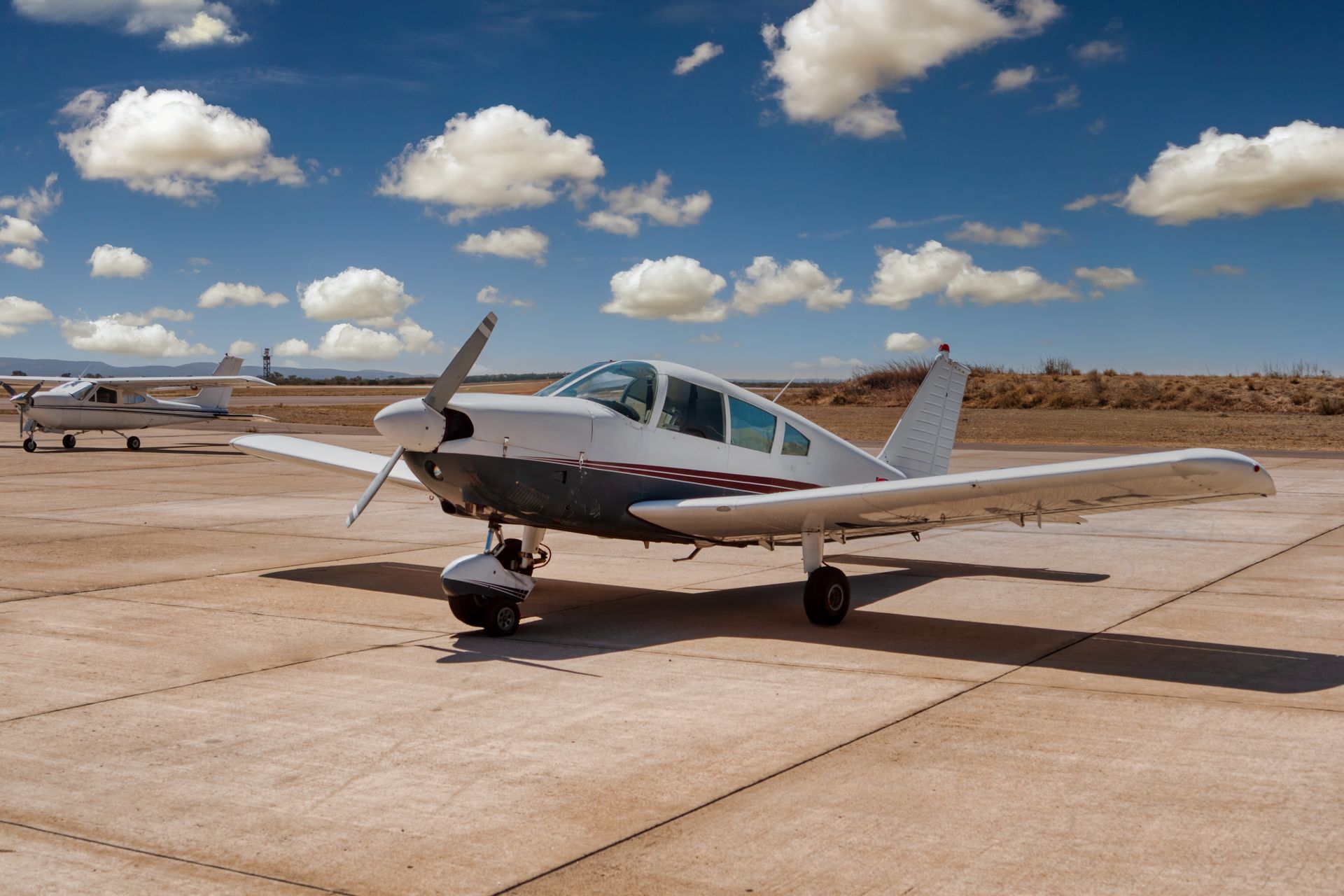 A small propeller plane is parked on a runway.