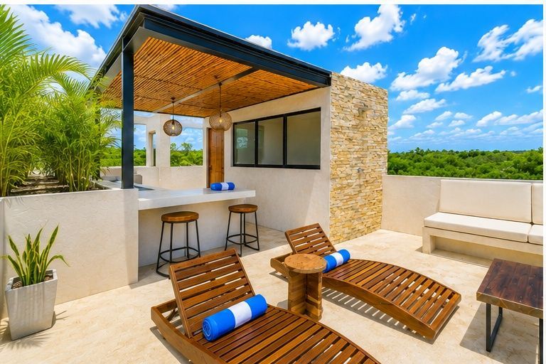 Rooftop terrace with wooden loungers, bar stools, and a small outdoor kitchen under a blue sky