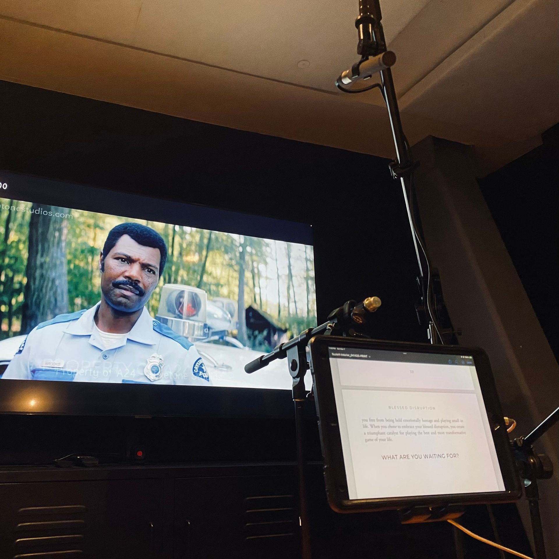 ADR recording setup with microphone, script, and dialogue on a movie screen