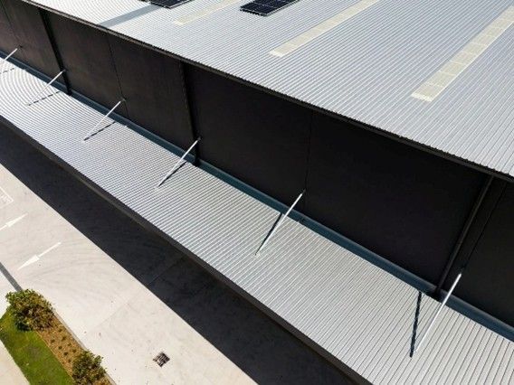 High-angle aerial view of a large industrial warehouse. High-angle aerial view of a large industrial warehouse.