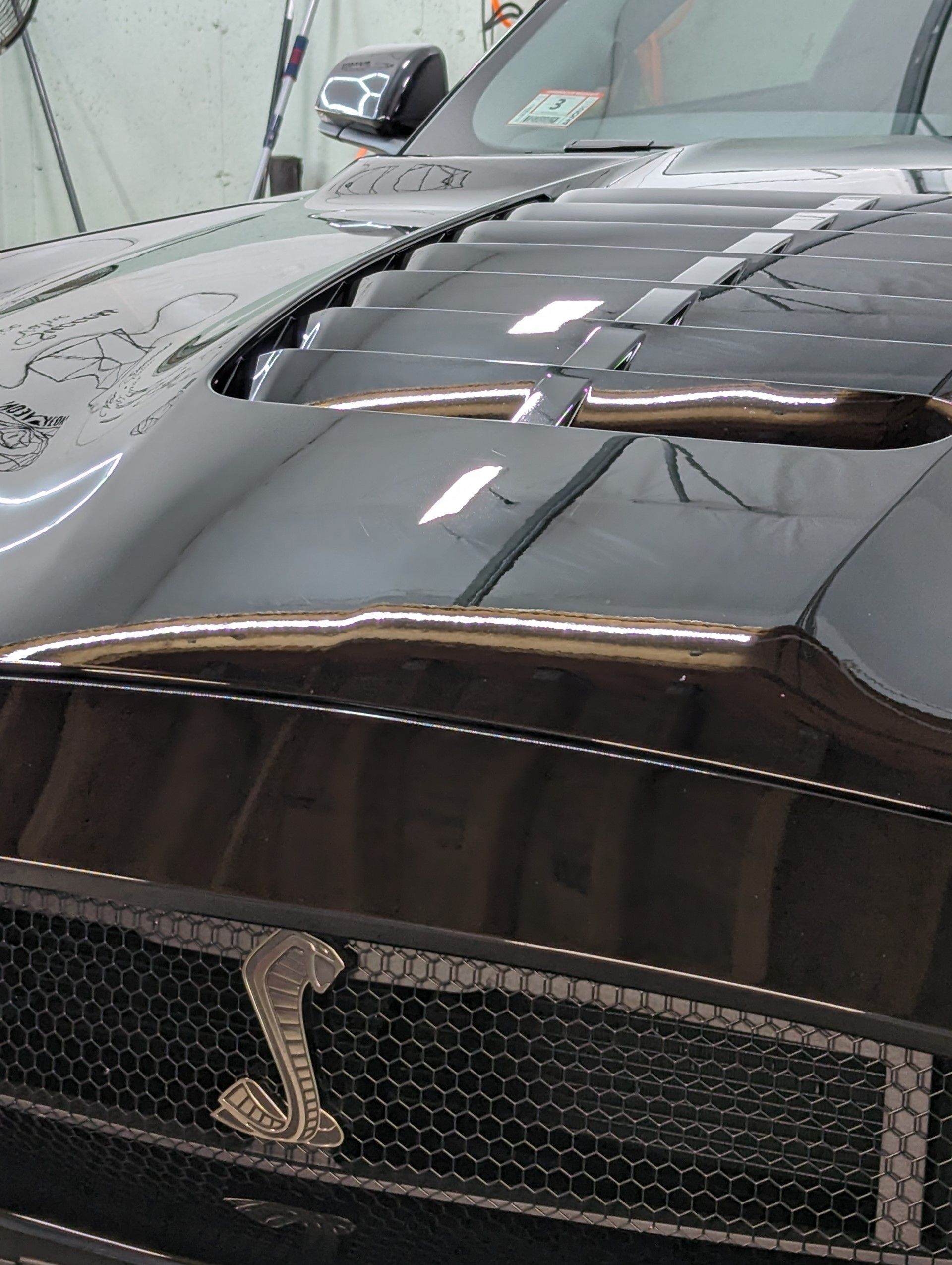 a close up of a black car with the hood open