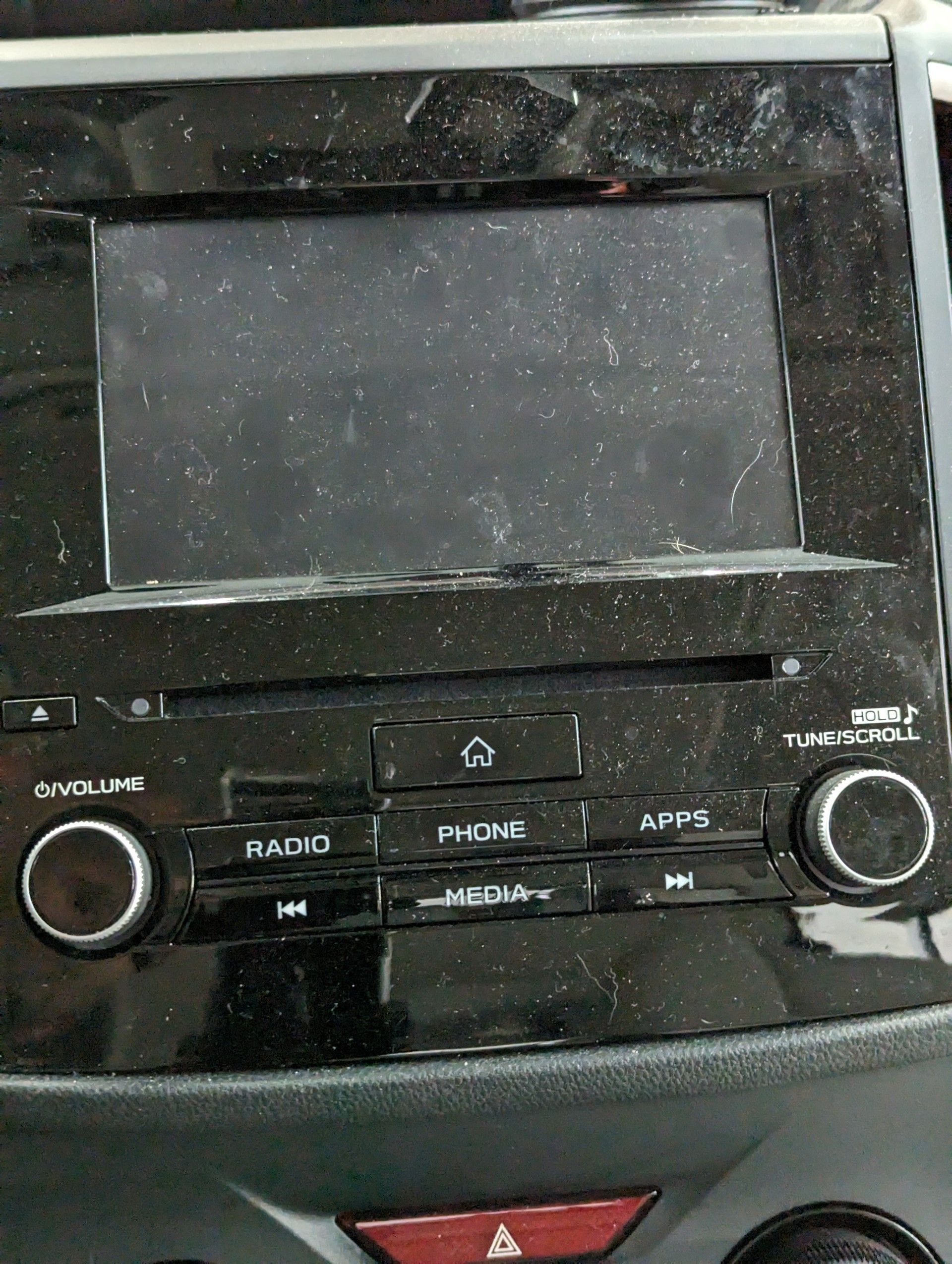 Before Interior Detailing - A dirty car radio with buttons for radio and phone