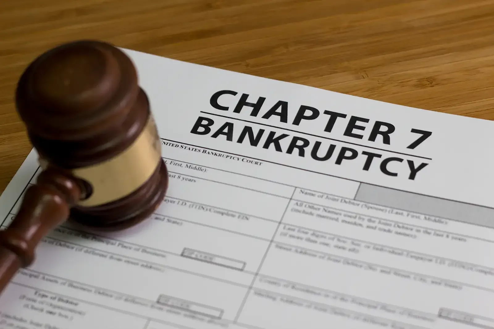 Image with a gavel and a form representing Chapter 7 bankruptcy.