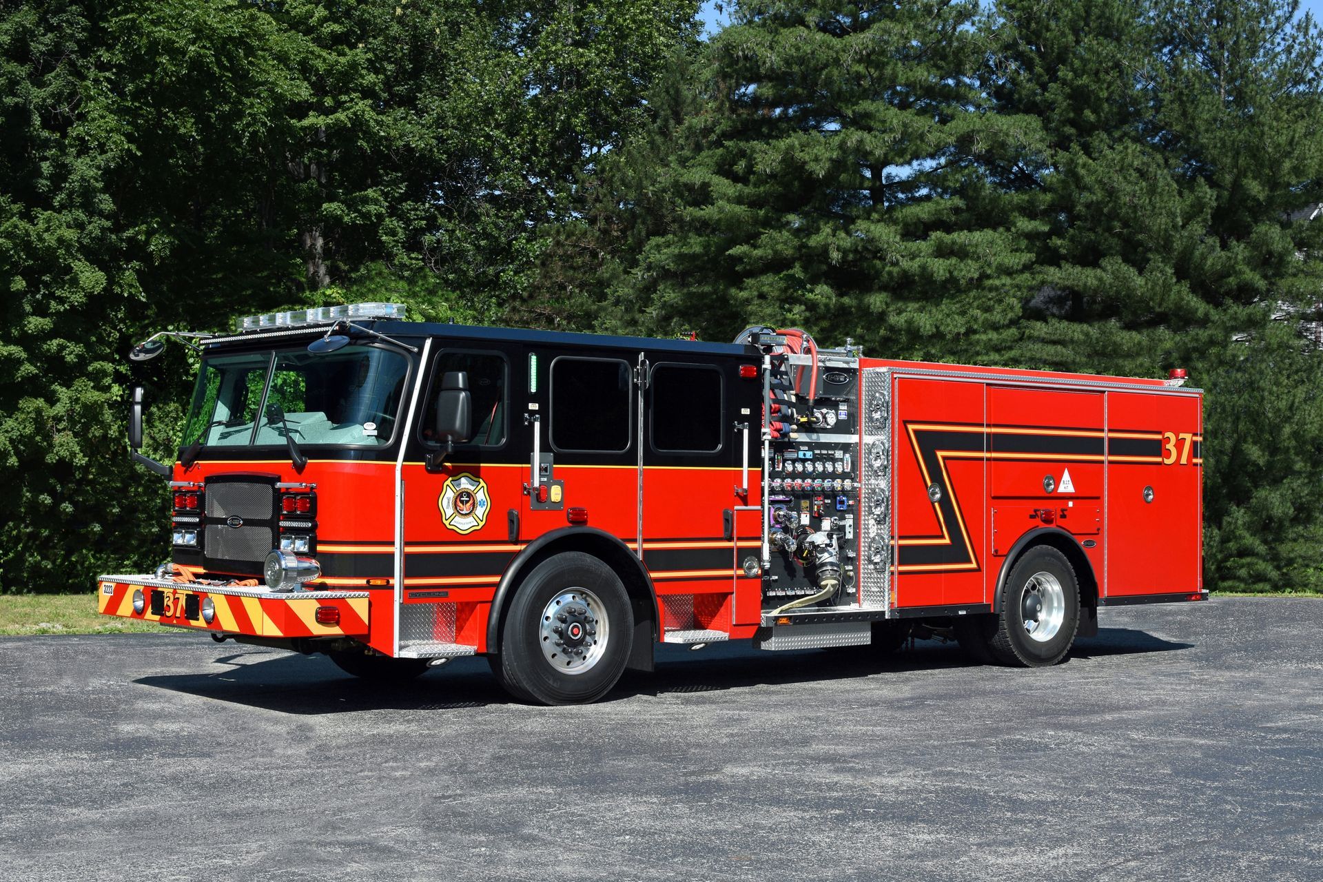 Red fire truck parked outdoors; black roof, silver trim, and equipment compartments.