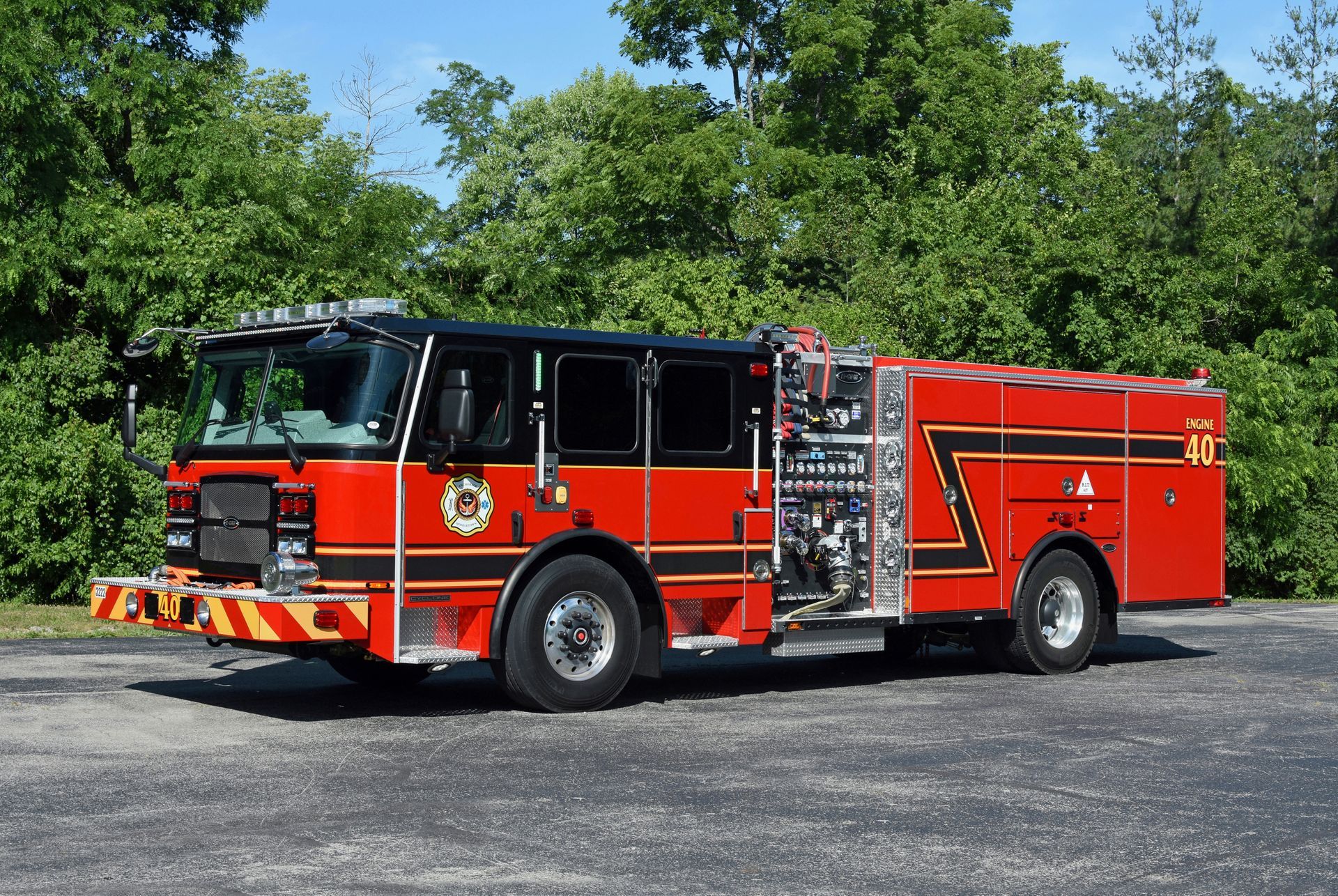 Red and black fire truck parked outdoors, displaying equipment.