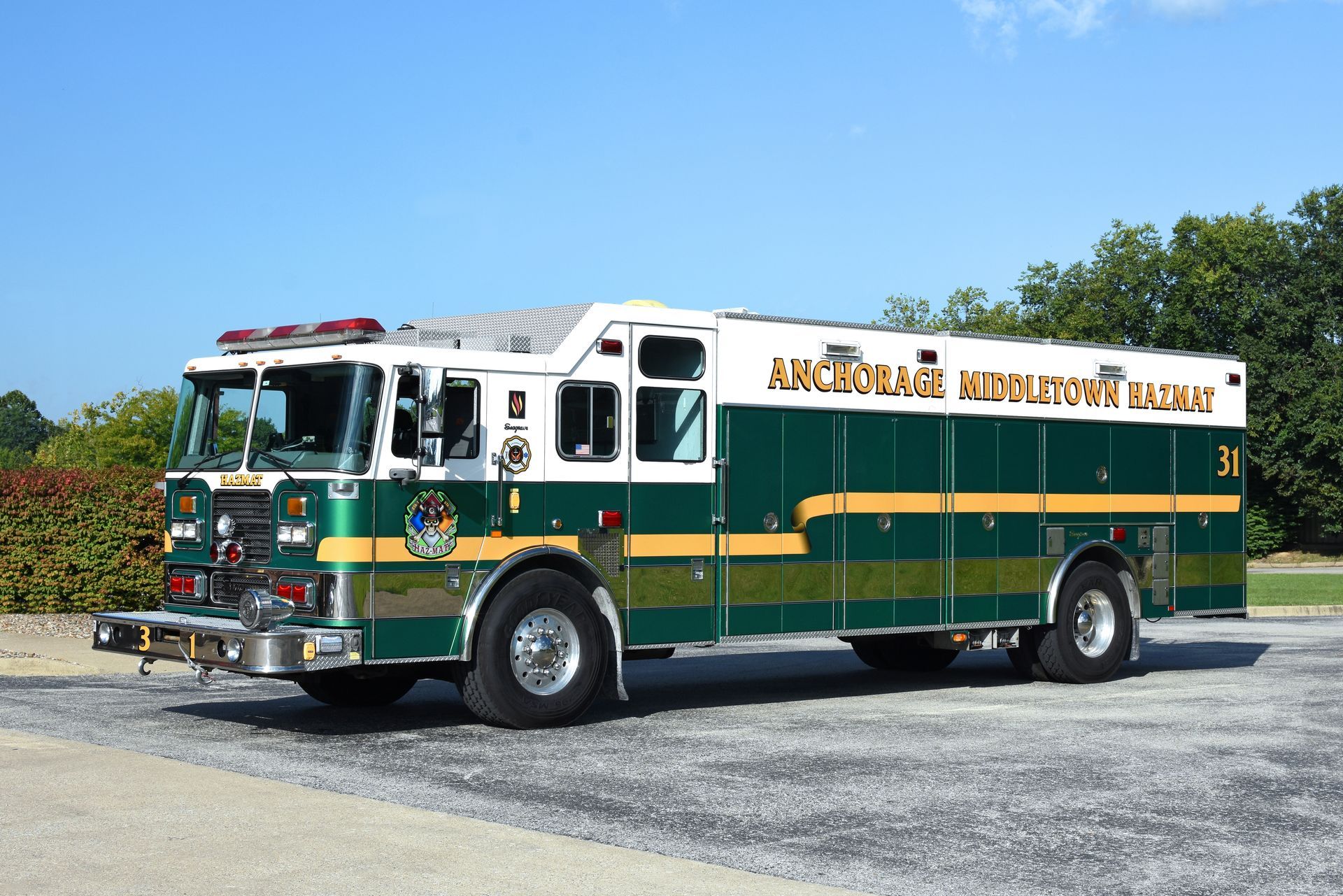 Green and white fire engine parked outdoors with text 