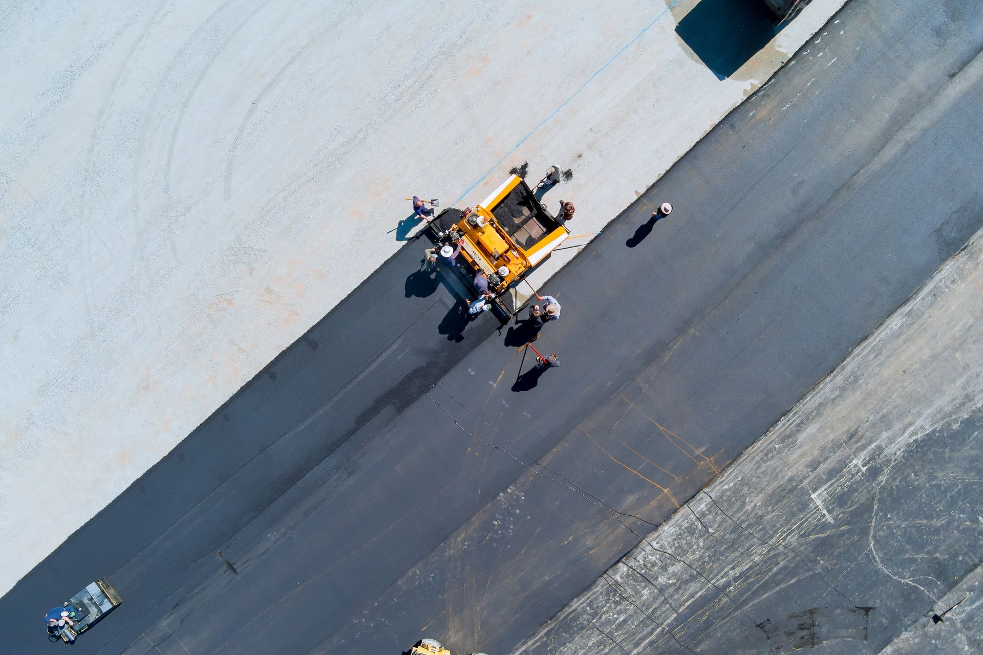 A crew is paving a parking lot.