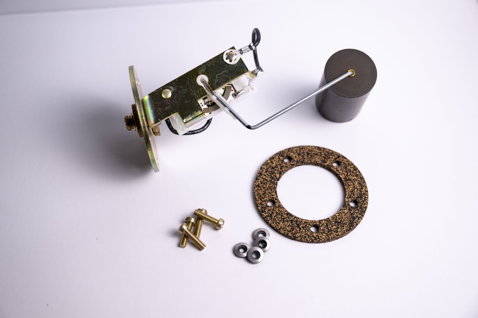 Fuel tank sending unit with a float, gasket, and mounting hardware.