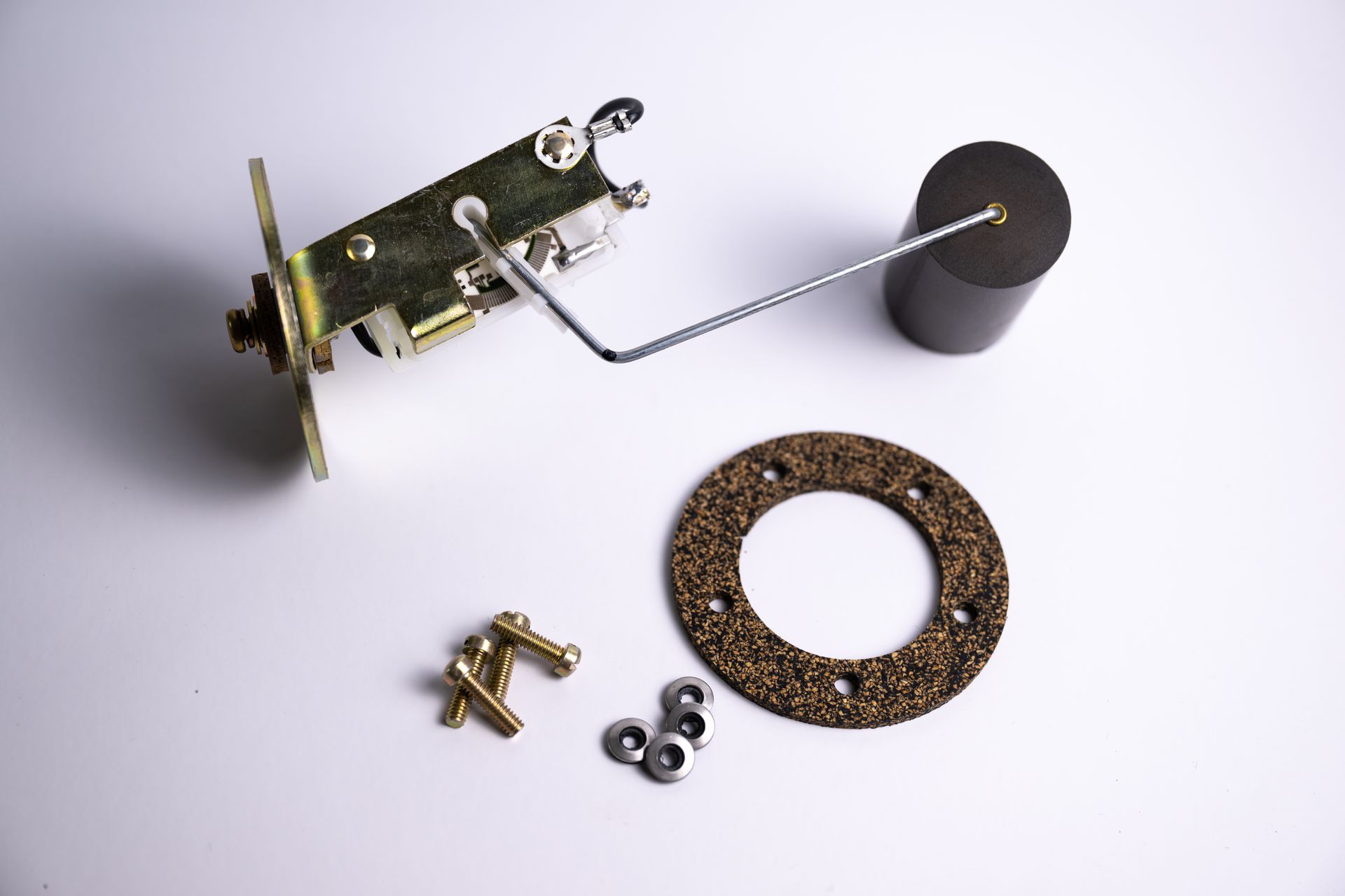 Fuel tank sending unit with float, gasket, and mounting hardware.