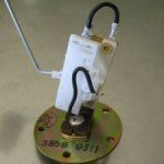 Fuel sending unit with a metal base, plastic body, and float arm.