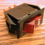 Red and black rocker switch labeled 