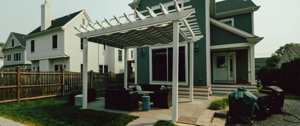 Beige outdoor cabinet with a slat-style countertop and a central stainless steel drop-in insert, on a white background.