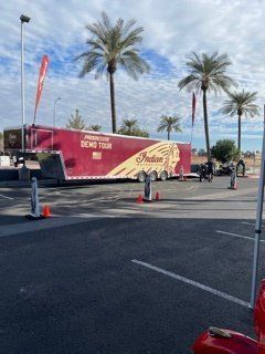 Indian Motorcycle Demo Tour trailer in a parking lot. Palm trees in background.