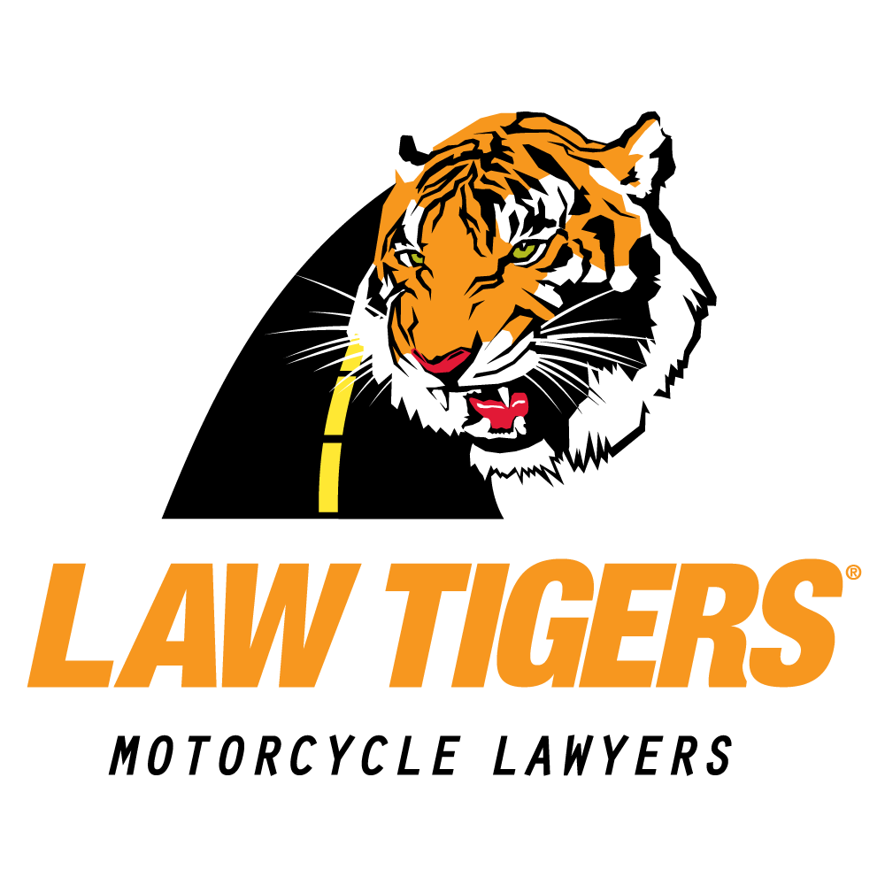 Law Tigers motorcycle lawyers logo with tiger head and orange text on a black road background