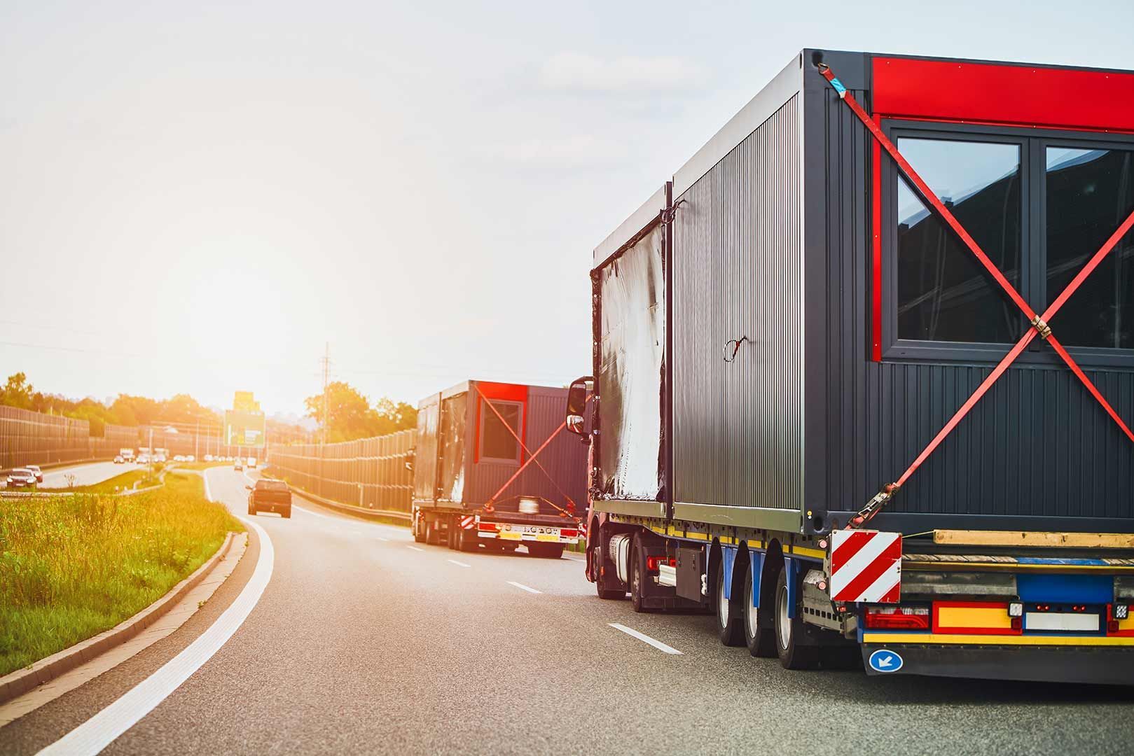 A Truck Is Carrying A Container Down A Highway — Gympie/Childers Towing Pty Ltd in Kybong, QLD