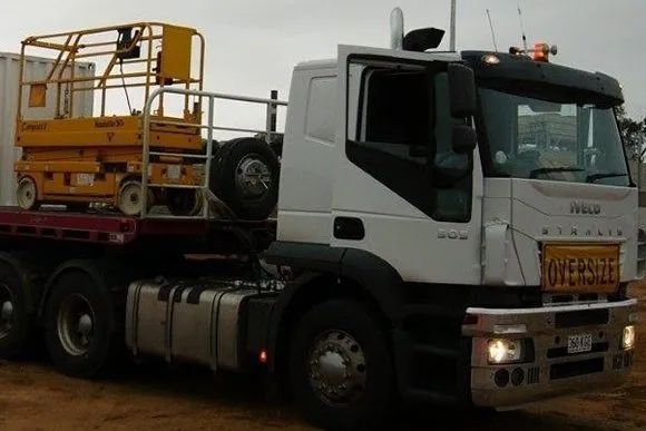 A White Truck With A Yellow Scissor Lift On The Back Of It — Gympie/Childers Towing Pty Ltd in Kybong, QLD