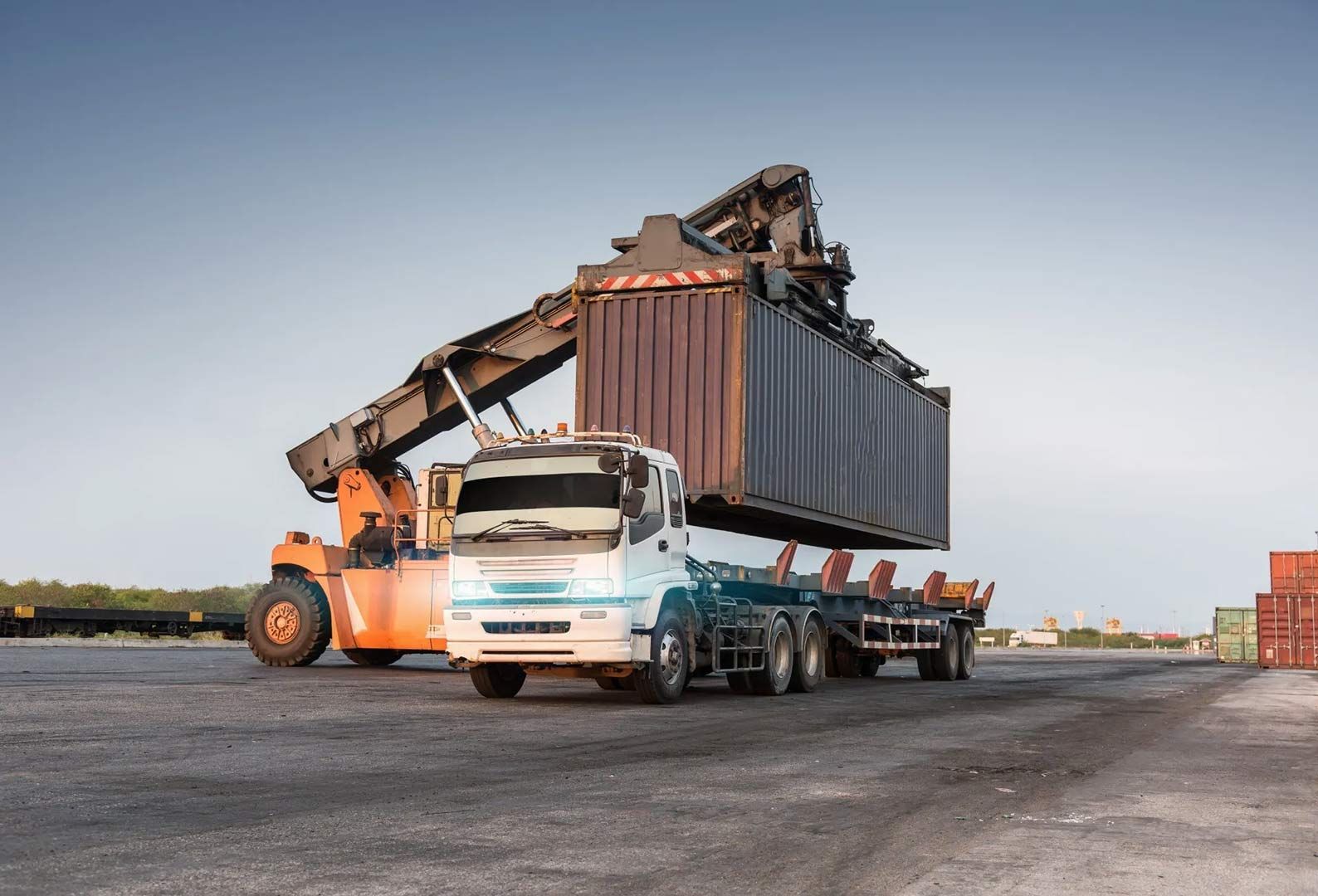 A Truck Is Being Loaded With A Container In A Warehouse — Gympie/Childers Towing Pty Ltd in Kybong, QLD