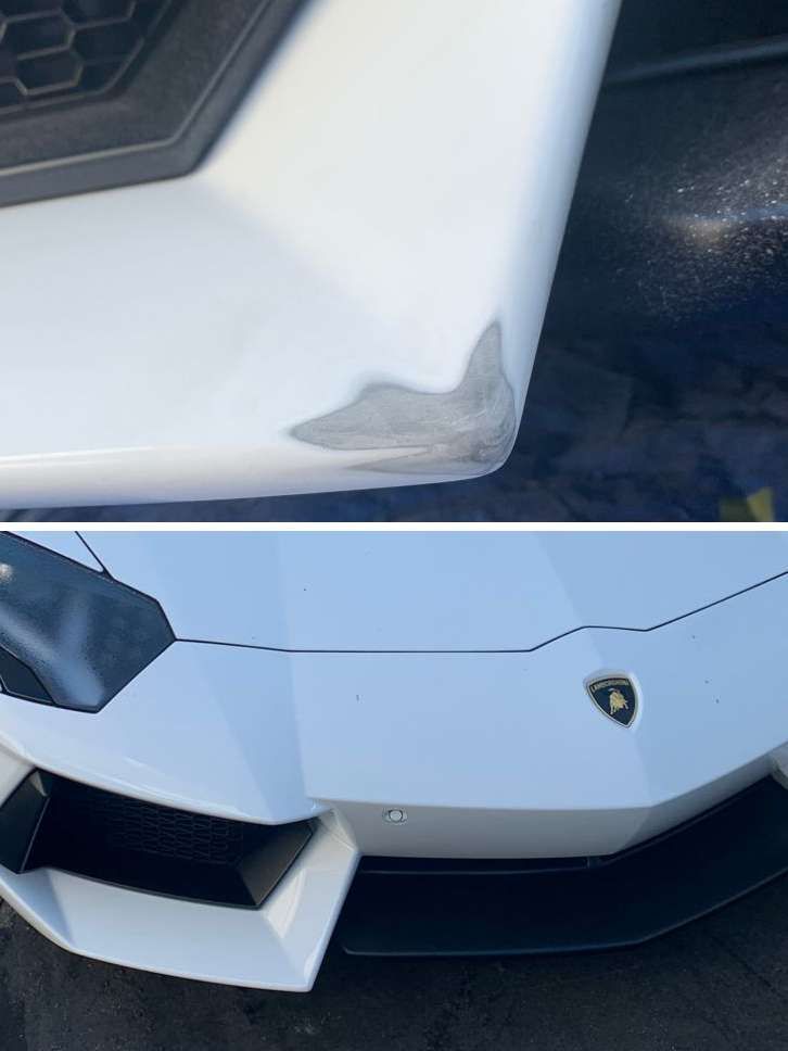 Close-up of a white Lamborghini with a dented front corner and scuffed bumper.