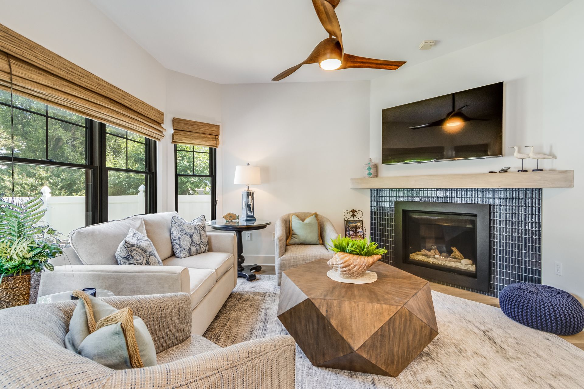 Cozy living room with fireplace, white walls, and beige furniture.