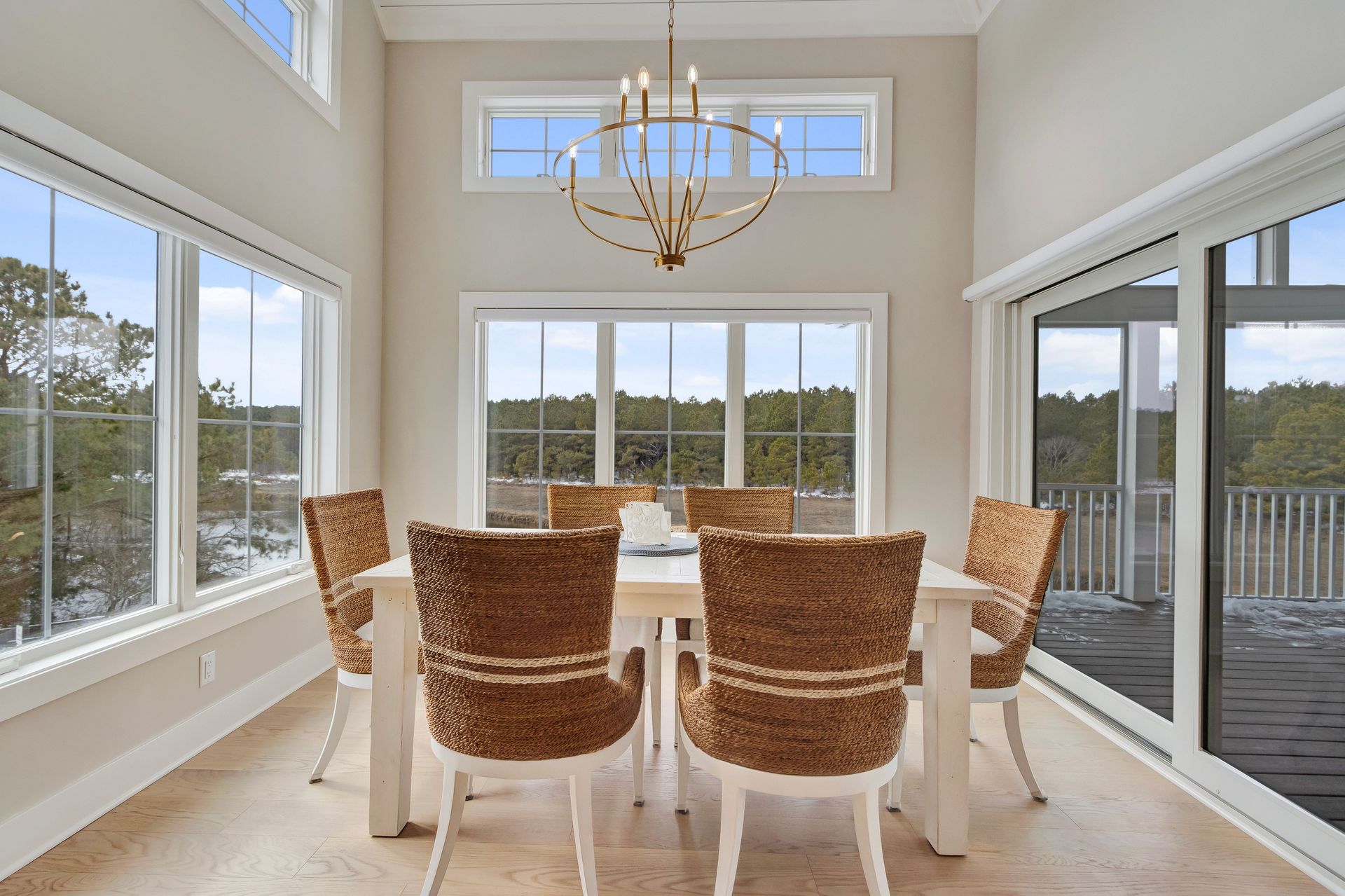 Dining room with table and chairs. Large windows offer a view.