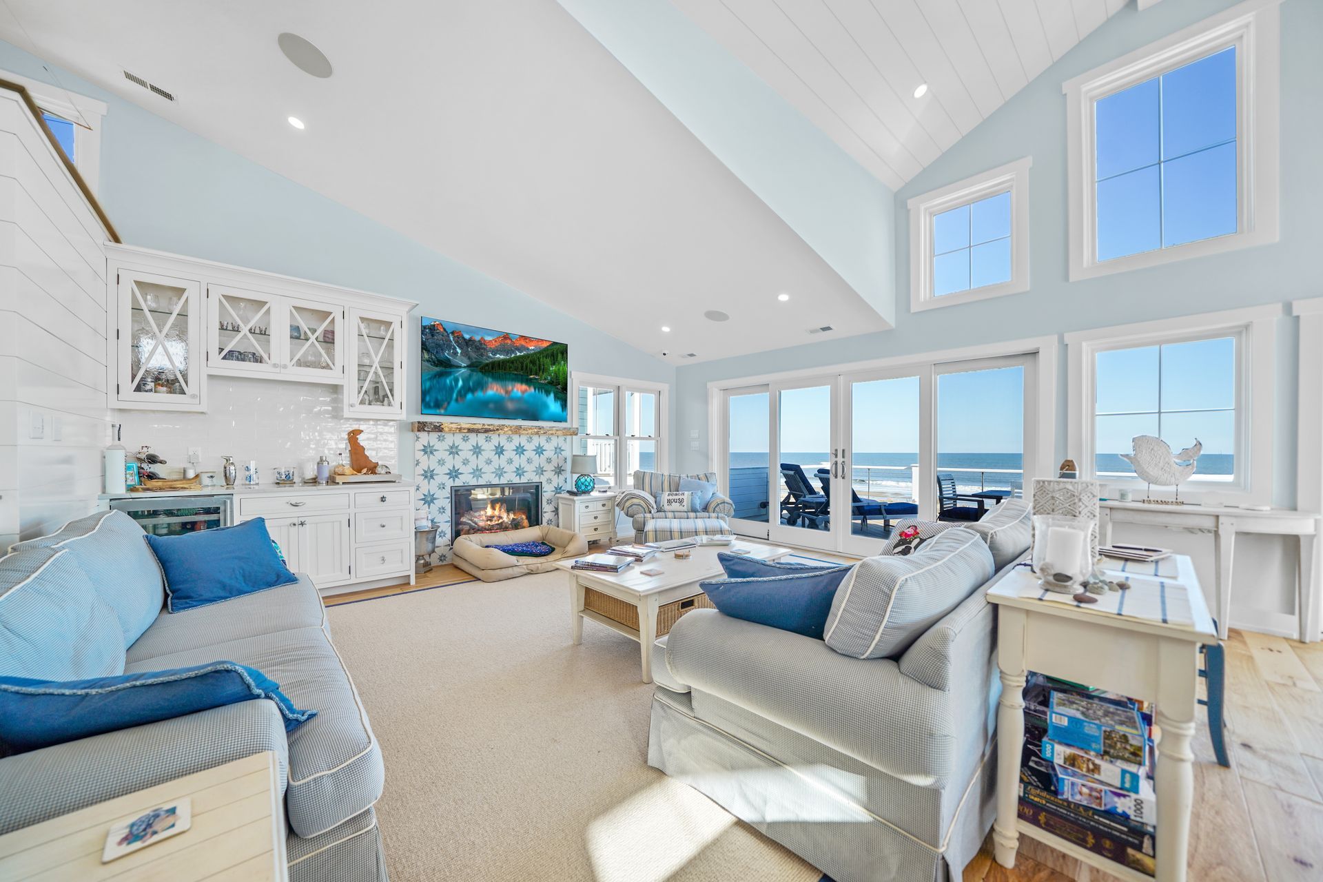 Coastal living room with blue walls, white trim, and ocean view.
