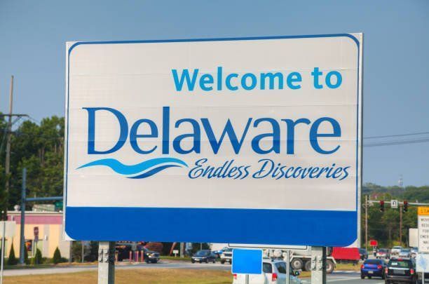 Welcome to Delaware sign with blue and white text.