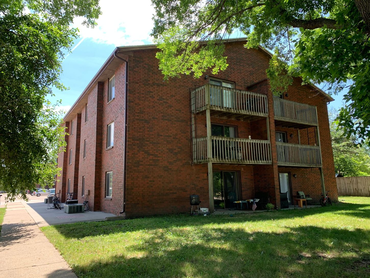 a large brick apartment building with a lot of windows and balconies .