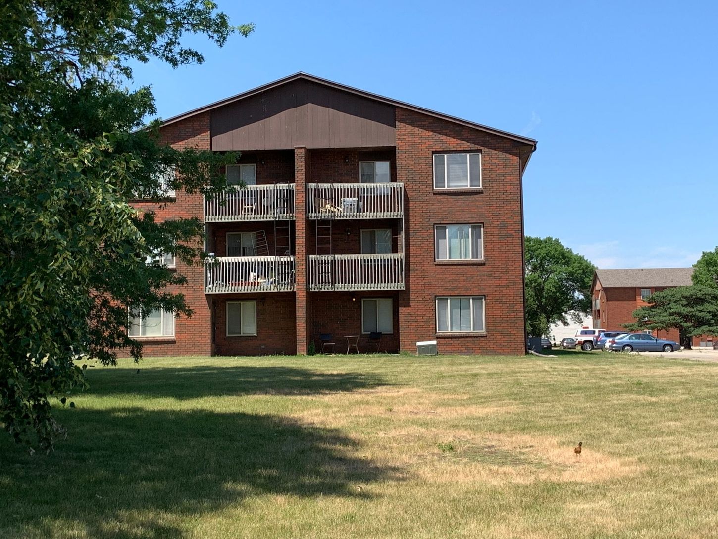 a large brick apartment building with a lot of balconies