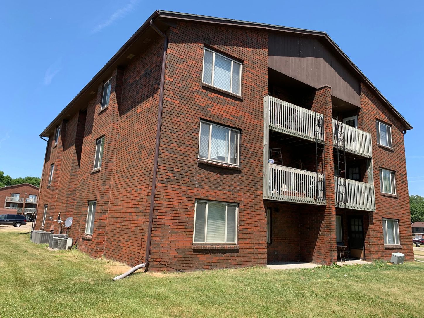 a large brick apartment building with a lot of windows and balconies .