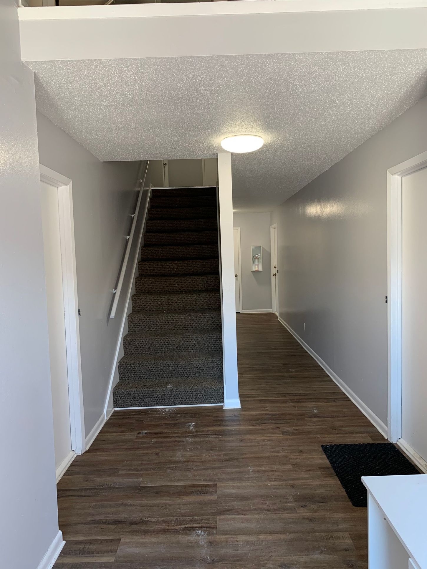 a hallway with stairs leading up to the second floor of a house .