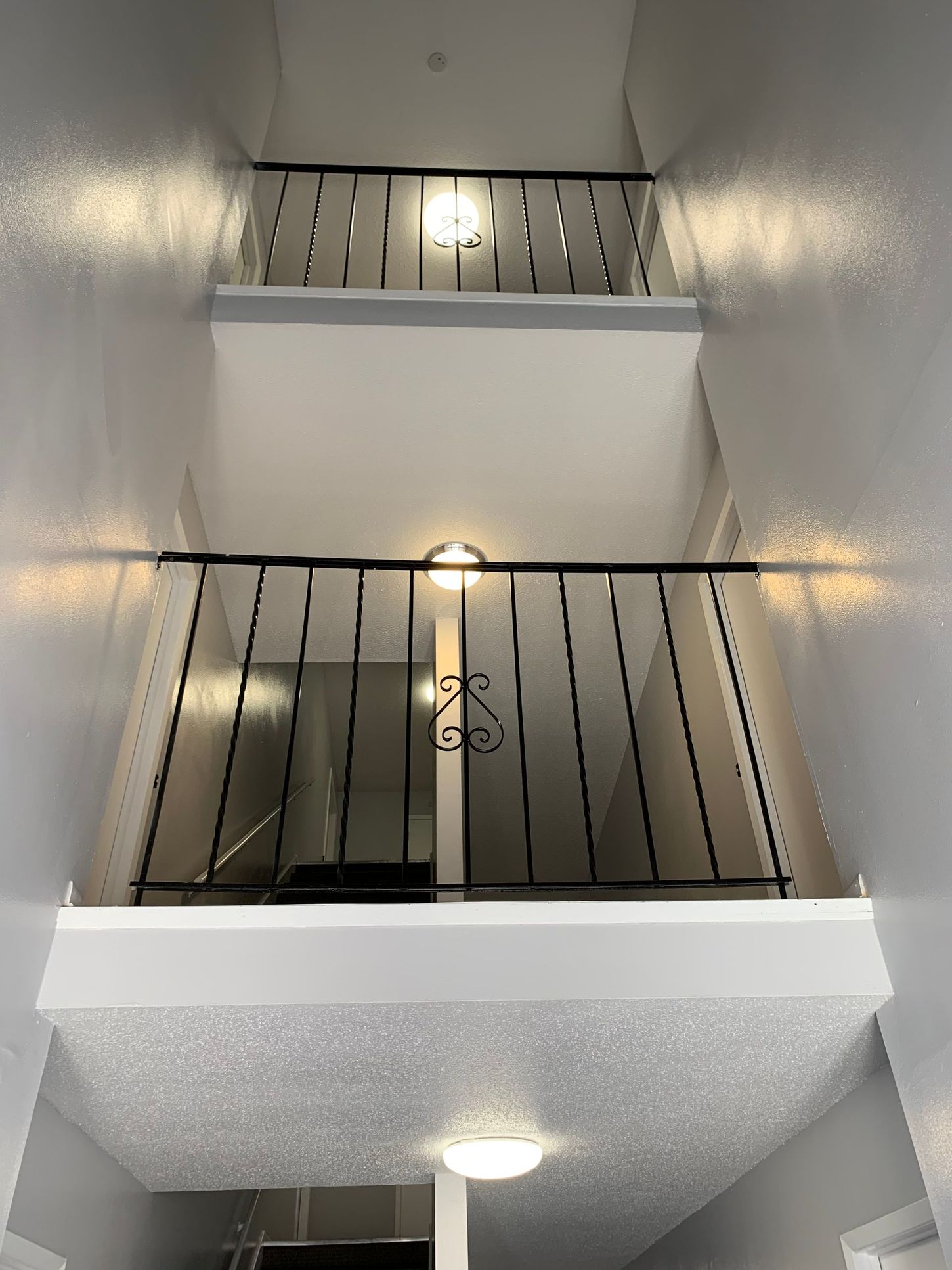 a staircase with a balcony in the middle of it