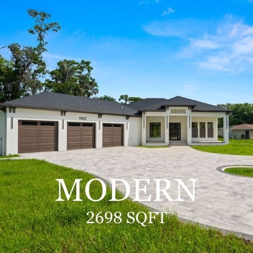 Modern white house with brown garage doors and driveway, 2698 sqft, on green grass under blue sky.