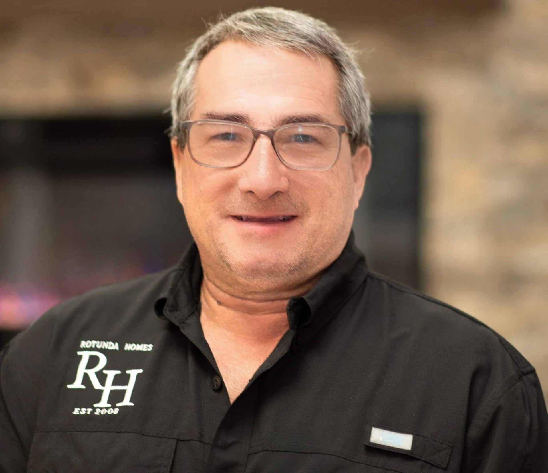 Man wearing glasses and black shirt with