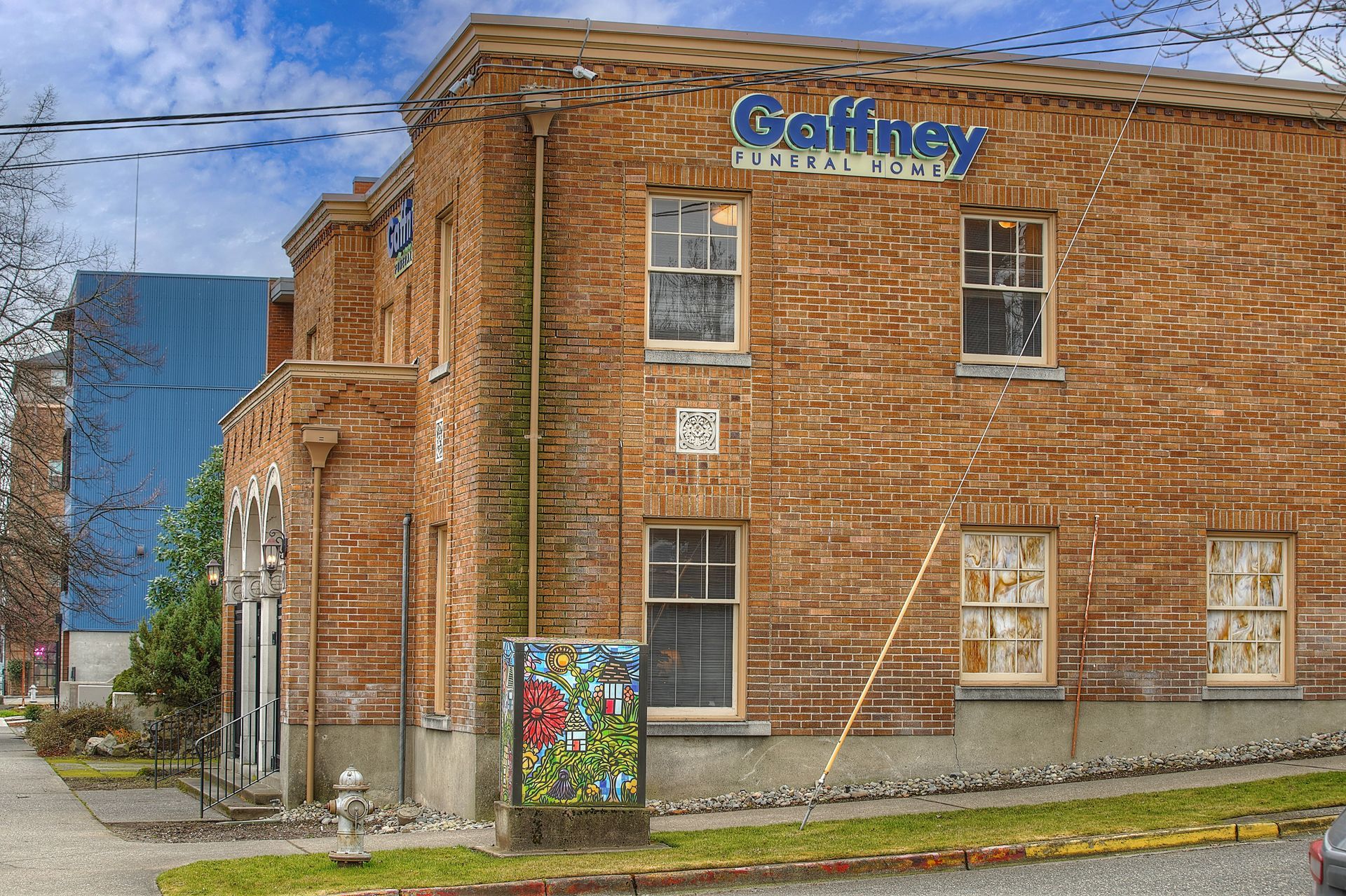 The front of a brick building with a porch and steps