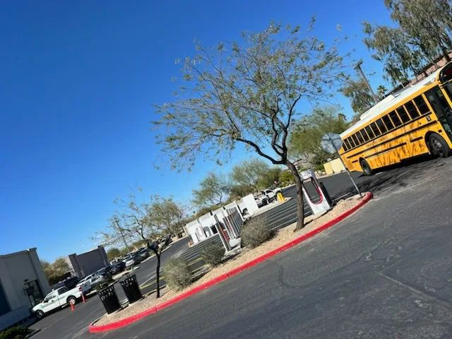 A yellow school bus is parked in a parking lot