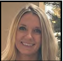 Smiling blonde woman indoors, with soft lighting and a blurred background.