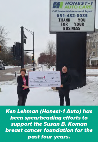 Two people holding an oversized check outside Honest-1 Auto Care; a sign reads “Thank you for your business.”