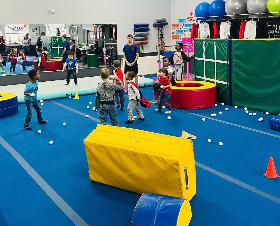 A group of children are playing in a gym.