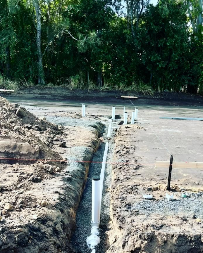 A Drain Pipe is Being Installed in the Dirt — Shawline Plumbing and Drainage In Iluka, NSW