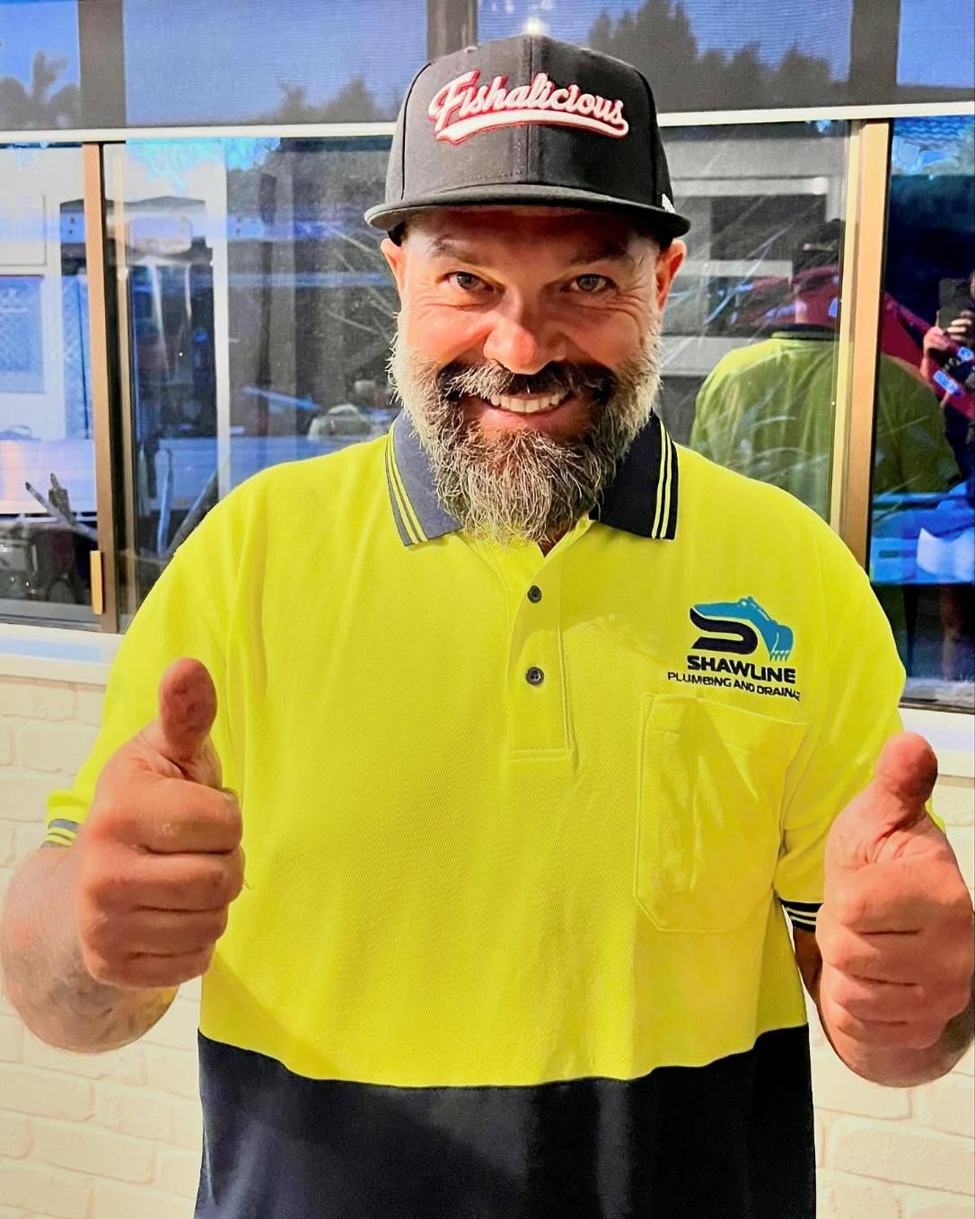 A Man With a Beard is Wearing a Yellow Shirt and Giving a Thumbs Up — Shawline Plumbing and Drainage In Iluka, NSW