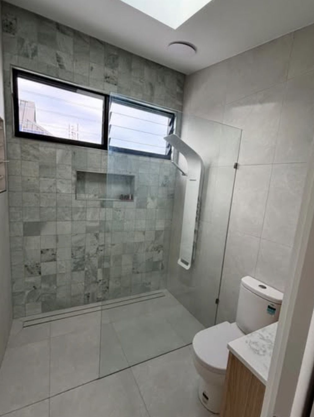 A Bathroom With a Toilet, Shower, and Window — Shawline Plumbing and Drainage In Iluka, NSW