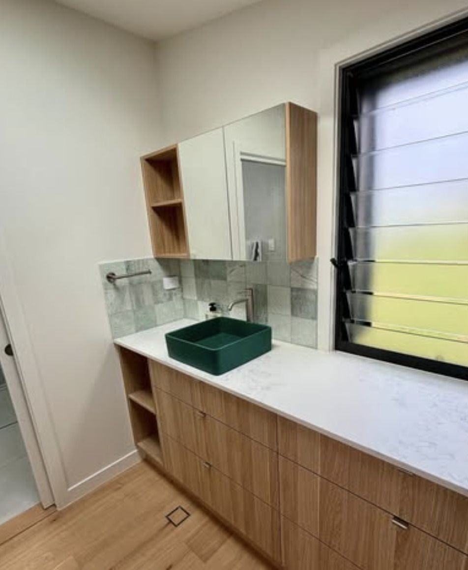 A Bathroom With a Sink, Mirror and Window — Shawline Plumbing and Drainage In Evans Head, NSW