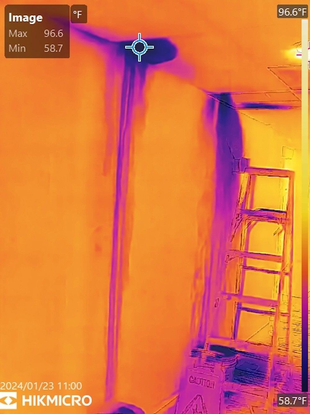 A man is holding a thermal leak detector in a room — Shawline Plumbing and Drainage In Iluka, NSW