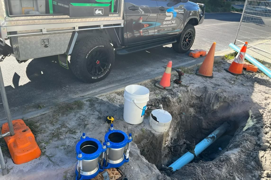 A Truck is Parked on the Side of the Road Next to a Hole in the Ground — Shawline Plumbing and Drainage In Iluka, NSW